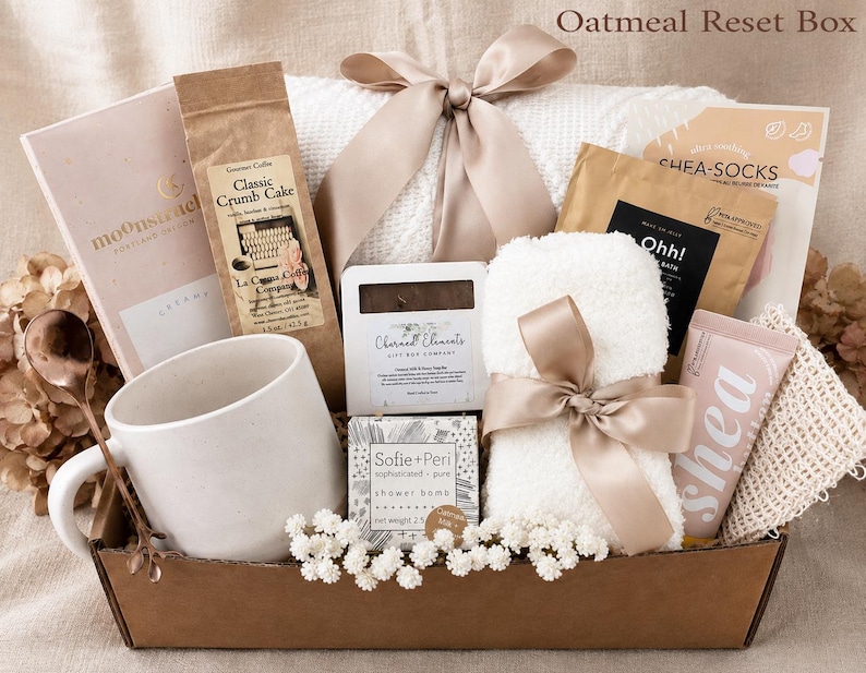 Puede incluir: Una caja de regalo etiquetada como Oatmeal Reset Box que contiene una taza de cer&aacute;mica blanca, una cuchara de cobre, una bolsa de Classic Crumb Cake, un jab&oacute;n Charmed Elements, una bomba de ducha Sofie+Peri, un art&iacute;culo blanco difuso y crema de karit&eacute;.