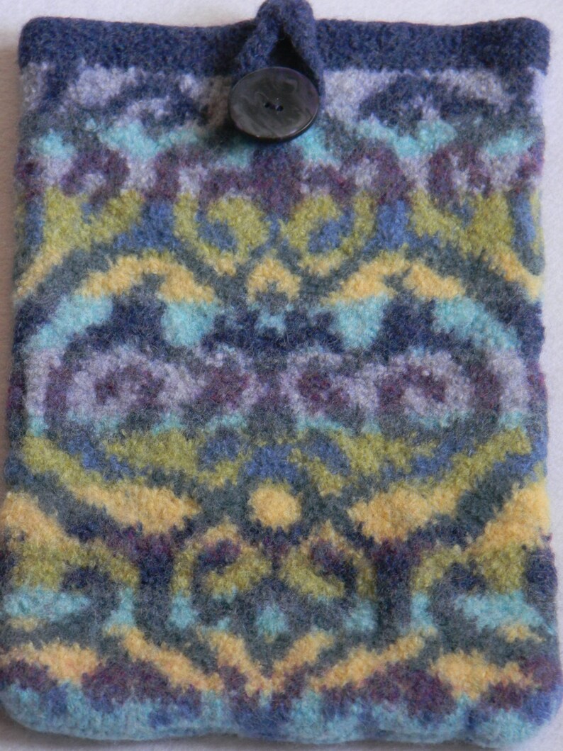 May include: A blue, green and yellow knitted phone case with a black button.