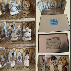 May include: A vintage paper doll set featuring a diorama of a room with painted walls and curtains. The set includes several paper dolls in period dresses and additional outfits, all stored in a box. The box has a label with the text "Le Mode Chic Le Psyche".