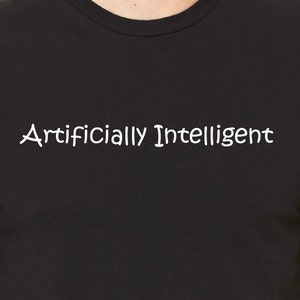 May include: Black t-shirt with the text "Artificially Intelligent" printed in white.
