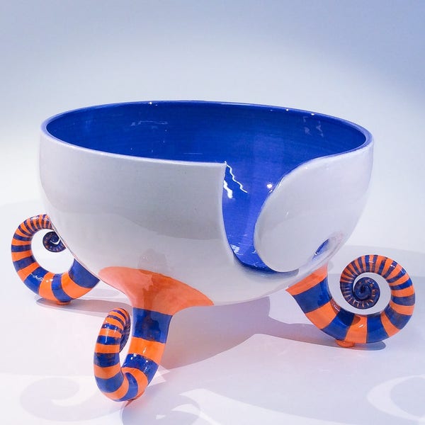 SALE ITEM. Yarn bowl in blue and orange stripey socks.