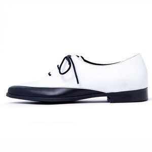 May include: White leather lace-up shoes with a black toe and heel.