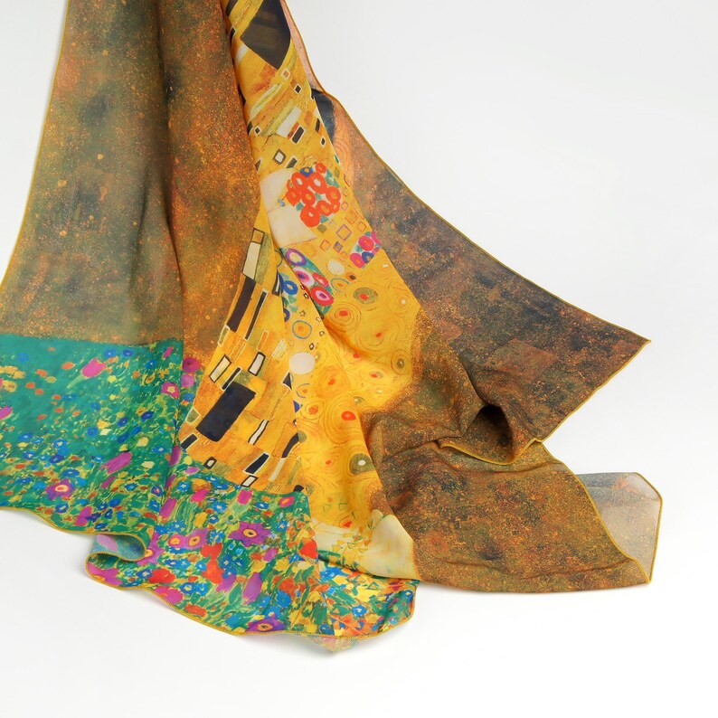 May include: A yellow, green, and blue silk scarf with a printed image of Gustav Klimt's "The Kiss" painting.