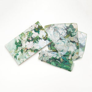 May include: Set of three fabric napkins featuring a green and white floral print inspired by a famous painting. The napkins are made of a soft, lightweight fabric and are perfect for adding a touch of elegance to any table setting.