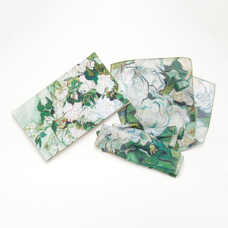 May include: Set of three fabric napkins featuring a green and white floral print inspired by a famous painting. The napkins are made of a soft, lightweight fabric and are perfect for adding a touch of elegance to any table setting.