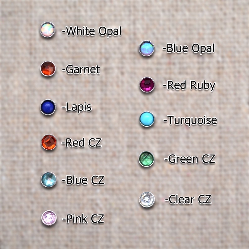 May include: A selection of colorful gemstones and crystals, including white opal, blue opal, garnet, lapis, red ruby, turquoise, red CZ, blue CZ, pink CZ, green CZ, and clear CZ.