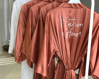 Personalized ankle length satin Bridesmaid robes in burnt orange, with a lavish white lace bride robe—Free shipping to the US over 35 USD.