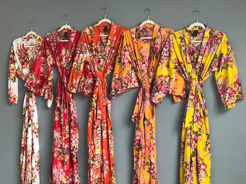 a group of women's robes hanging on a wall