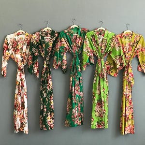 a group of women's kimonos hanging on a wall
