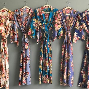 a group of women's robes hanging on a wall