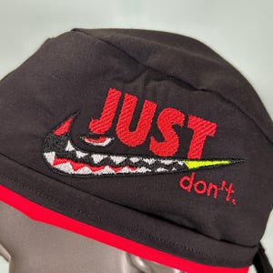 black nike hat with red swoosh