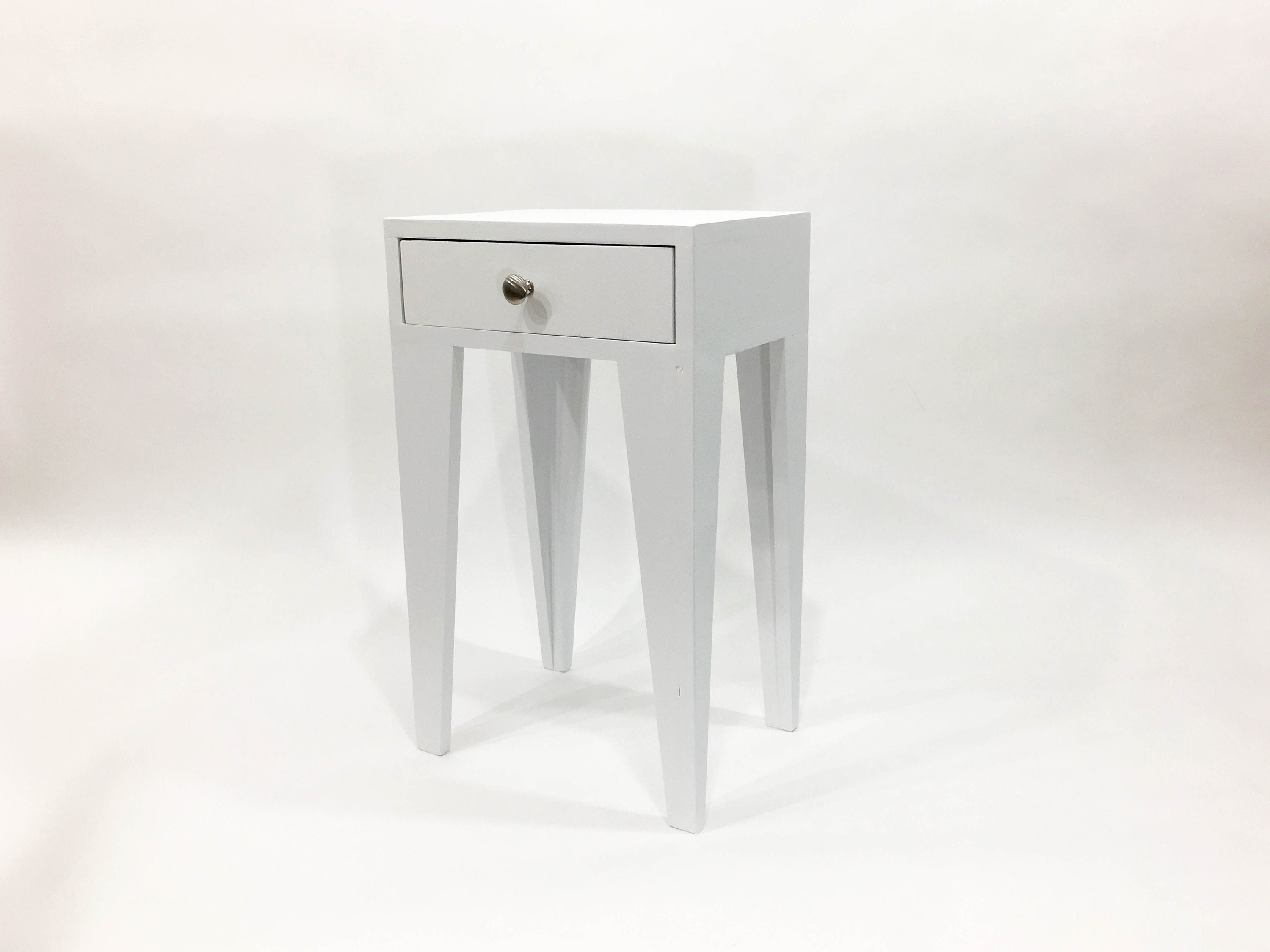 White bedside table with outlet silver legs
