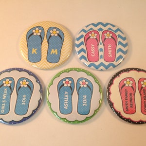 May include: Six round, colorful buttons with flip-flop designs. Each button features a different design and text, including "Girl's Week 2014", "Ashley 2014", "Smith Family Reunion Coney Island August 2014", "Cassy Smith", and "KM".