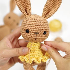Sewing together a crocheted toy bunny
