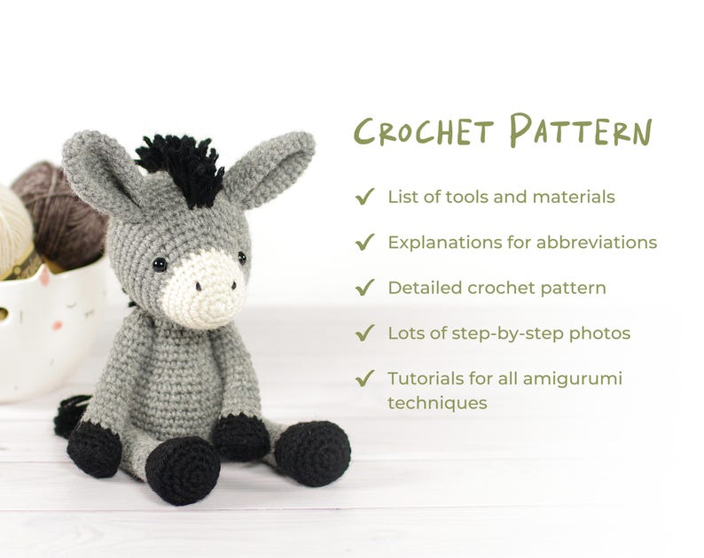 May include: A crocheted donkey amigurumi in gray, black, and white, with the text "CROCHET PATTERN" and bullet points listing pattern features. The donkey has a black mane, ears, and hooves, with a white muzzle. The pattern includes tools, abbreviations, photos, and techniques.