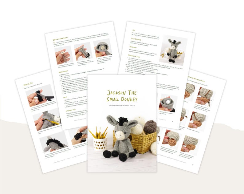 May include: A crochet pattern titled "Jackson The Small Donkey" with step-by-step instructions and images. The pattern is accompanied by a finished gray donkey toy with black accents, sitting next to a basket of yarn and a small yellow cup.