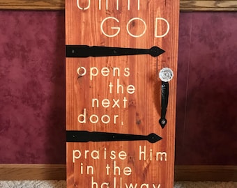 Until God Opens The Next Door, Praise Him In The Hallway sign featuring a crystal door knob