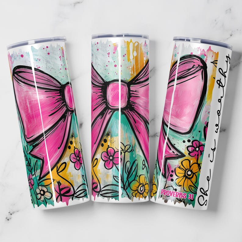 May include: Three white stainless steel tumblers with a pink bow design, floral accents, and the text "She is worthy" and "Proverbs 31". The tumblers have a colorful, abstract background with teal, yellow, and pink hues.