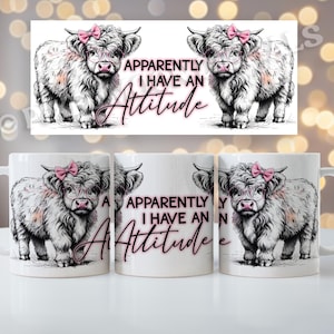 May include: White ceramic mug with a black and white illustration of a Highland cow with a pink bow. The text "Apparently I have an attitude" is printed in pink on the mug.