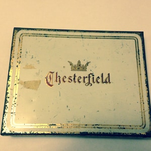 May include: Vintage Chesterfield cigarette tin with a gold border and a crown above the brand name.