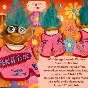 May include: Vintage Uneeda Wishnik Troll doll, approximately 9 inches tall, with teal hair and bulging eyes. The doll wears a pink vest with the phrase "Sock-It-To-Me" and other sayings. A retro collectible.