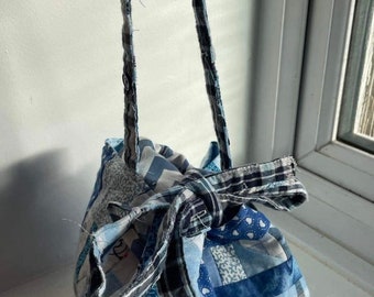 A blue patchwork Japanese Rice Bag with some upcycled fabric