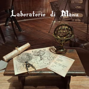 Puede incluir: Una pequeña mesa de madera exhibe un pergamino enrollado, un mapa, una brújula y un globo celeste. La mesa está en una habitación con el texto "Laboratorio di Manu" encima. El globo es dorado y el mapa es beige.