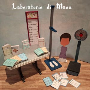 May include: Miniature medical office scene with a height chart, scale, and medical records. The height chart displays measurements in centimeters. The scene includes a small table with books and papers, and a cutout figure of a child.