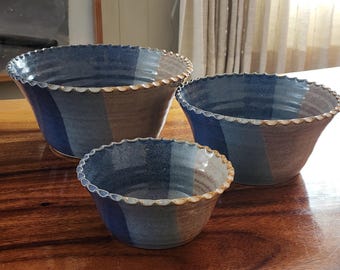 Set of 3 hand made, hand glazed, ceramic nesting bowls. These hand signed bowls have a multiple glaze dip finish and intricate detailed rim