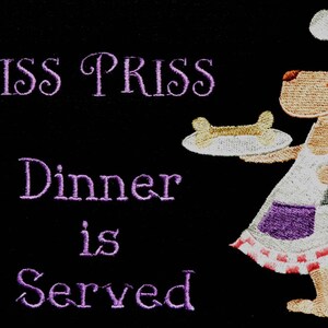 May include: A cartoon dog wearing a chef's hat and apron holds a plate with a bone on it. The text "Miss Priss Dinner is Served" is embroidered in purple on a black background.