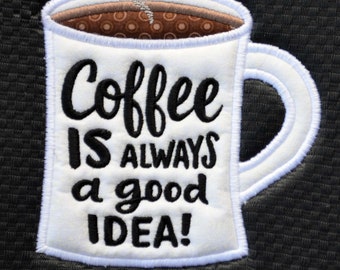 May include: An embroidered patch featuring a white coffee mug on a black background. The mug contains brown liquid with a pattern and a white steam swirl. The black text reads: Coffee IS ALWAYS a good IDEA! The design has a white stitched border.