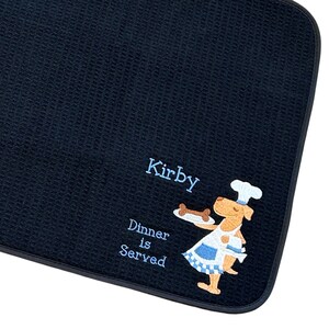 May include: Black and white dog-themed kitchen mat with the text "Kirby Dinner is Served" and a cartoon dog wearing a chef's hat and holding a bone on a plate.