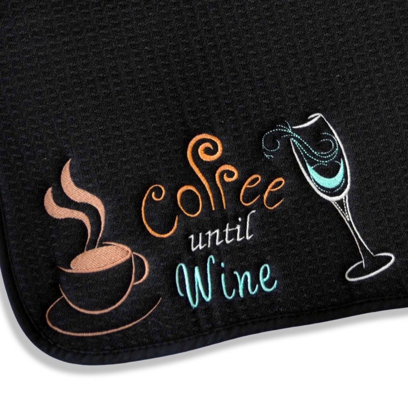 May include: Black kitchen towel with embroidered text "Coffee until Wine" with a coffee cup and a wine glass.
