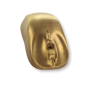 May include: A gold-coloured computer mouse with a scroll wheel and buttons. The mouse has a smooth, rounded design and is set against a white background. The mouse is a wireless type.