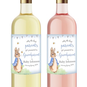 May include: Two wine bottles, one white and one pink, with gold caps. Each bottle has a label with the text "only the best parents get promoted to Grandparent" and a watercolour illustration of a rabbit. The text "Baby Johnson" is also on the label.