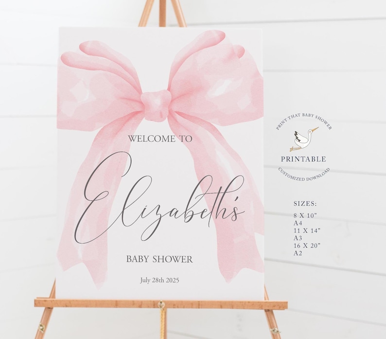 May include: Printable baby shower welcome sign with a pink watercolor bow, the text "Welcome to Elizabeth's Baby Shower" and the date "July 28th 2025".