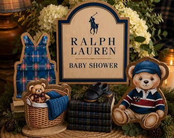May include: A Ralph Lauren Baby Shower sign with a polo player logo, featuring wooden cutouts of a teddy bear in a basket, a teddy bear in a rugby shirt and cap, blue plaid overalls, a stack of books, and a pair of small navy blue shoes.