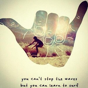 May include: A hand drawn in the style of a shaka sign with a surfer riding a wave inside the hand. The text below reads "you can't stop the waves but you can learn to surf".