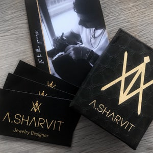 May include: Black jewellery box with gold embossed logo "A. SHARVIT Jewellery Designer" and a gold geometric design.
