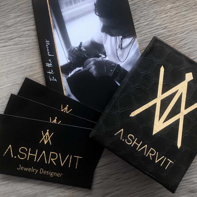 May include: Black jewellery box with gold embossed logo "A. SHARVIT Jewellery Designer" and a gold geometric design.