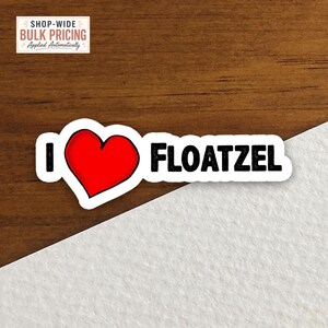 May include: A die-cut sticker featuring the text I, a red heart symbol, and the word FLOATZEL in bold black capital letters. The sticker has a white border and a clean, simple design with a high-contrast appearance for clear readability.