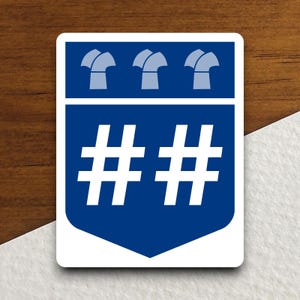 May include: A blue and white sticker with a shield shape. The shield has three white symbols at the top and two white hashtags in the center. The text on the sticker reads "# #".