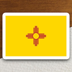 May include: A yellow flag with a red Zia symbol in the center. The Zia symbol is a stylized sun with four rays extending from it.