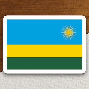 May include: A sticker featuring the flag of Rwanda. The flag is blue, yellow, and green with a yellow sun in the center.