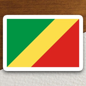 Könnte beinhalten: Ein Aufkleber mit der Flagge der Republik Kongo. Die Flagge ist ein diagonaler Dreifarbenstreifen in Grün, Gelb und Rot.