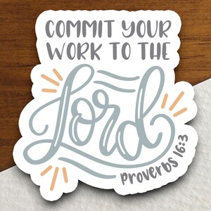 May include: A sticker with a white background and a blue and orange design. The sticker says "Commit your work to the Lord" and "Proverbs 16:3".