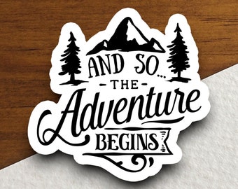 May include: Black and white sticker with a mountain, two pine trees, and the text "And so... the adventure begins."
