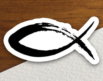 May include: A black and white stylized fish symbol, also known as the Ichthys, with a brushstroke design. The symbol is often used as a Christian symbol.