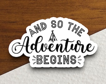 May include: Black and white sticker with the text "And so the adventure begins" with a stylized tent graphic.