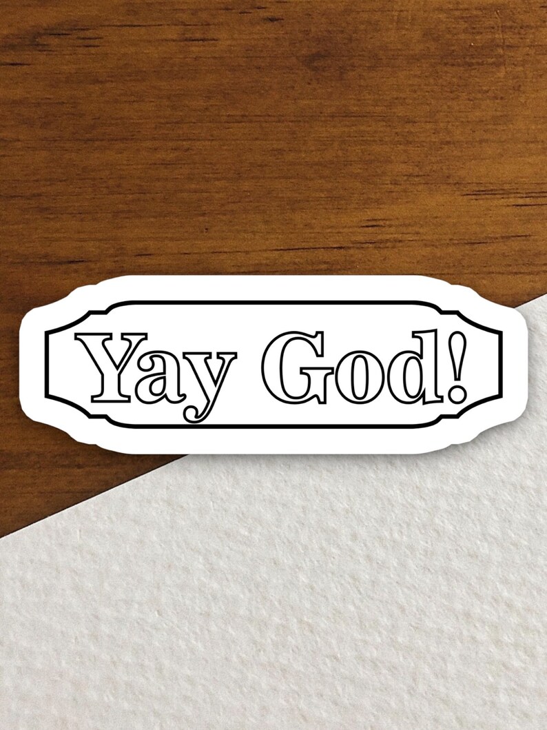 May include: White sticker with black outline and the text "Yay God!" in a decorative font.